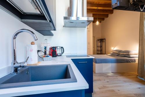 a kitchen with a sink and a bed in a room at Al Merlo da Diego in Cagliari