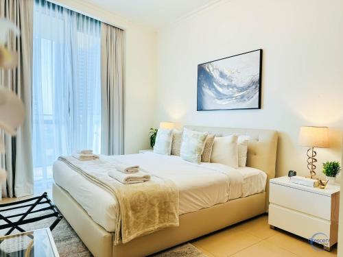 a bedroom with a bed and a large window at Burj Vista Burj Khalifa Metro & Mall Access in Dubai