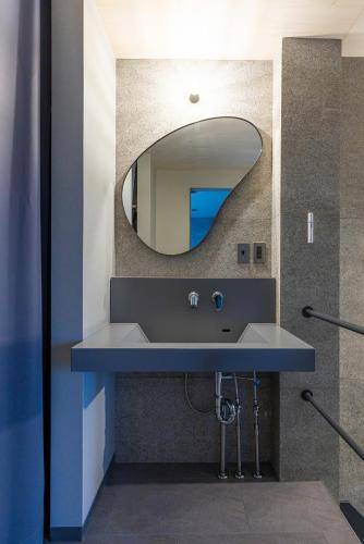 a bathroom with a blue sink and a mirror at B-sum M-1 in Matsuzaka