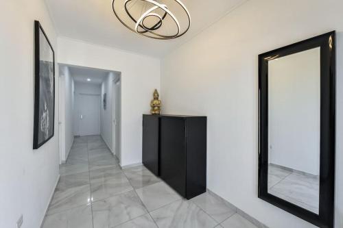 a hallway with a mirror and a chandelier at New Villa Luel 5 minutes from Palm Beach in Noord