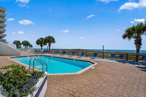 a swimming pool with the ocean in the background at SeaSpray East 624-Gulf Front in Pensacola