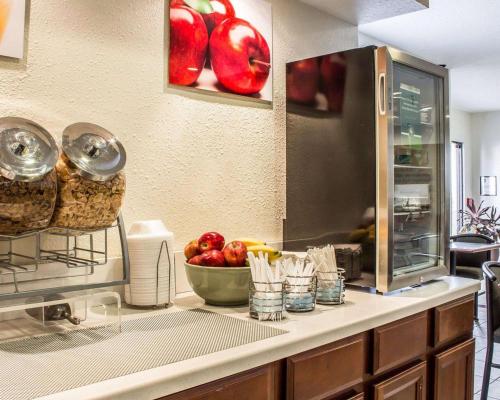 a kitchen with a counter with a bowl of apples at Quality Inn & Suites Yuma in Yuma