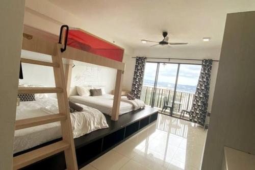a bedroom with two bunk beds and a balcony at Spacious i-City Studio home 3 Beds by Nuriman in Shah Alam