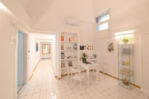 a white room with a desk and a window at Dimore De Luca in Amalfi