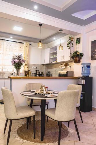 a dining room table and chairs in a kitchen at Greenwood Homes 1 Bedroom House in Nanyuki