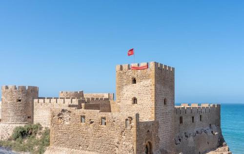 a castle with a flag on top of it at Appartement Cosy et Familial in Safi