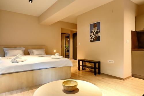 a bedroom with a large bed and a table at Central Studio Apartments by Parkside Boutique in Skopje