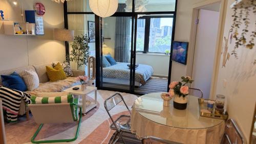 a living room with a table and a couch at Emporium-Melbourne Central-City view in shopping hotspots - Pokemon in Melbourne