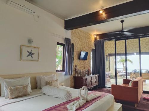 a bedroom with two beds and a large window at Villa Umbrella Lombok in Senggigi 