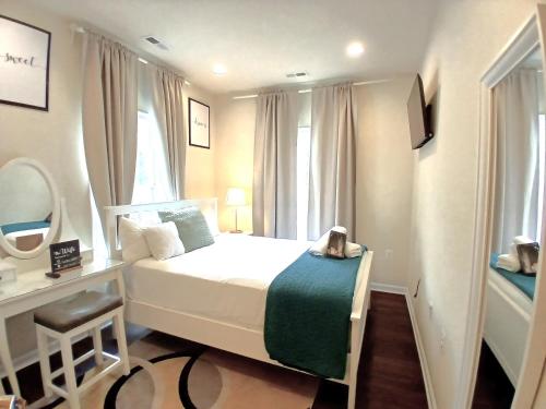 a small bedroom with a bed and a mirror at Luxury & Cherished Private Room in DC in Washington, D.C.