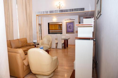 a living room with a couch and a table at One Pavilion Luxury Serviced Apartments in Manama