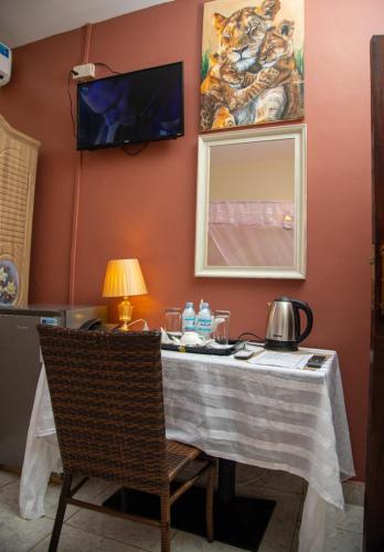 a table with a table cloth on it in a room at Lakeshore Bed and Breakfast in Entebbe