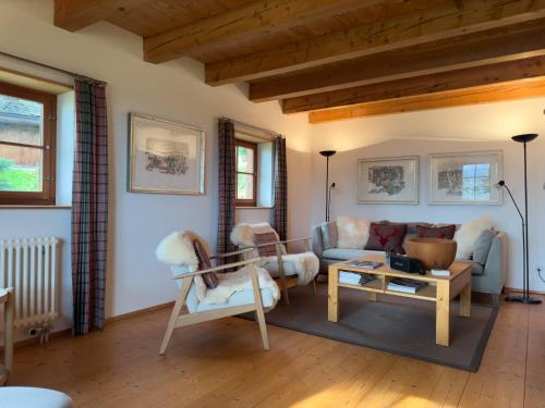 a living room with a couch and a table at Casa Seglias in Brigels
