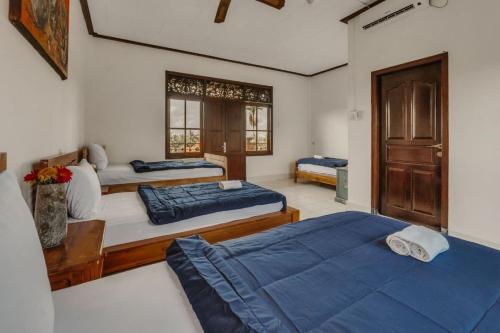 Postel nebo postele na pokoji v ubytování Ubud Backpacker Hostel