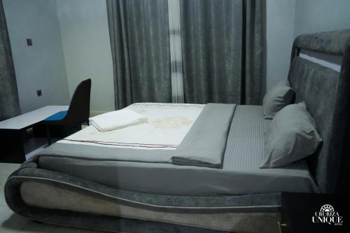a bed sitting in a room with at Uburiza Unique Hotel in Kayenzi