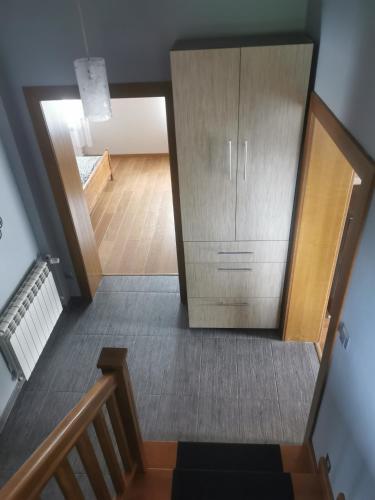 a stairway with a wooden cabinet in a house at Leśna Chatka in Śmigiel