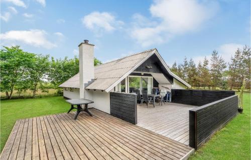 a house with a wooden deck in the yard at Holiday Home Klydevej Hurup Thy Xi in Sindrup