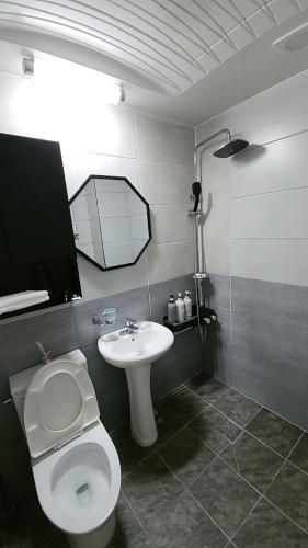 a bathroom with a toilet and a sink at Incheon Intl Airport ANN Guest House in Incheon