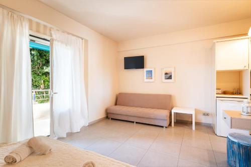 a living room with a couch and a window at Sun George in Finikounta