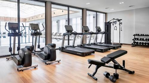 a gym with treadmills and elliptical machines at Alliance Palace Marriott in Batumi