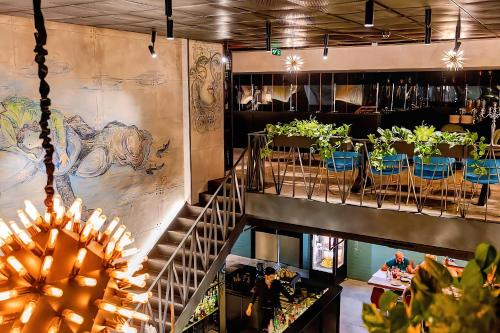 a restaurant with a staircase leading up to a dining room at Alliance Palace Marriott in Batumi