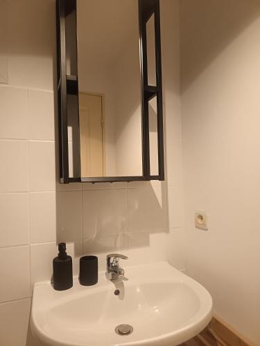 a white sink in a bathroom with a mirror at Charmant Studio in Marseille