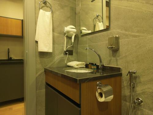 a bathroom with a sink and a mirror at Questa Deluxe Hotel in Trabzon