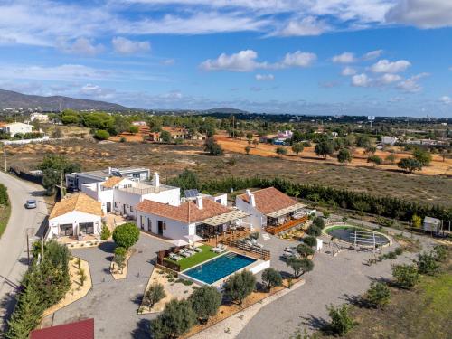 an aerial view of a house with a swimming pool at Alfarrobeiras NATURE -Agroturismo in Olhão
