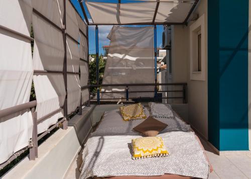 a bed on the back of a balcony at Sun George in Finikounta