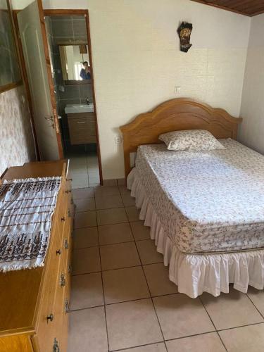 a bedroom with a bed and a bathroom with a mirror at Sarah Delight in Pýrgos