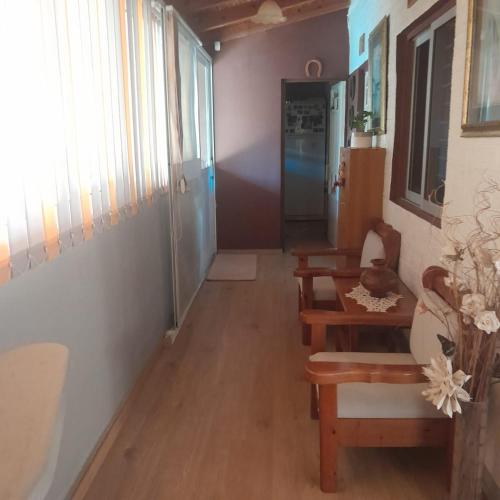 a hallway with a table and a chair and a door at Sarah Delight in Pýrgos