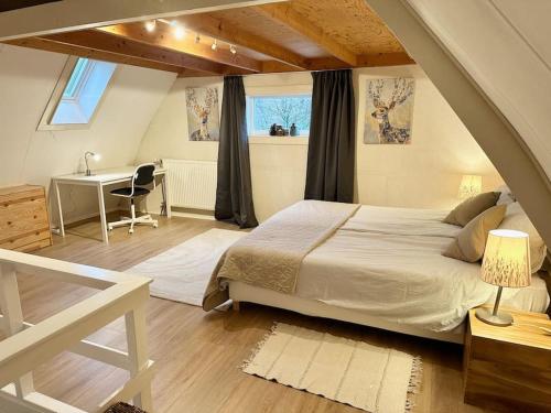 a bedroom with a white bed and a desk and a window at Charming villa,central location,train and bus nearby in Soest