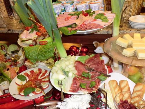 a bunch of plates of food on a table at Hotel Andra München in Munich