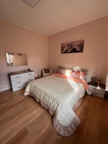 a bedroom with a large bed and a dresser at Isabel BGY house airport in Grassobbio