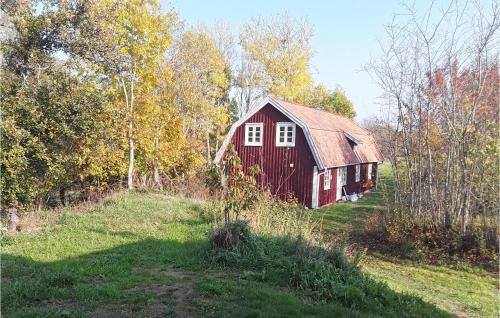 a red barn in the middle of a field at 5 Bedroom Lovely Home In Tving in Tving