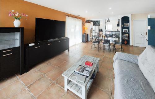 a living room with a couch and a table at Beautiful Home In Servian in Servian