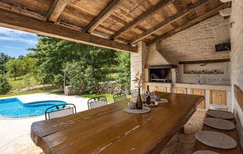 a kitchen and dining room with a table and a pool at Villa Castela in Vela Traba