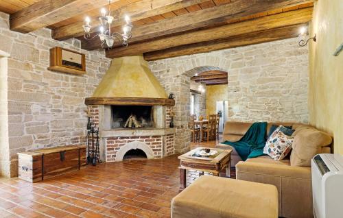 a living room with a large stone fireplace at Villa Castela in Vela Traba