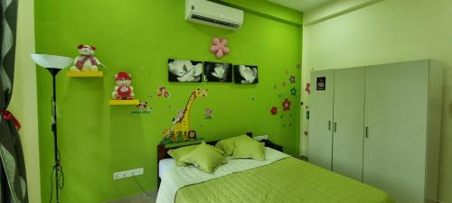 a green bedroom with a bed and a green wall at Wis Villa in Galle