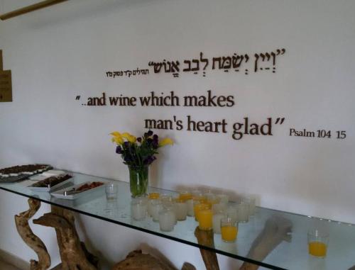 a glass table with some glasses of orange juice at Prima Park Hotel Jerusalem in Jerusalem