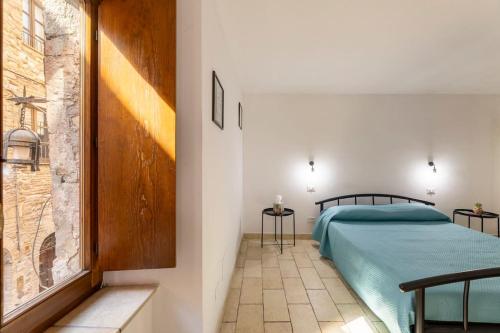 Postel nebo postele na pokoji v ubytování Cali - Casa in centro ad Assisi