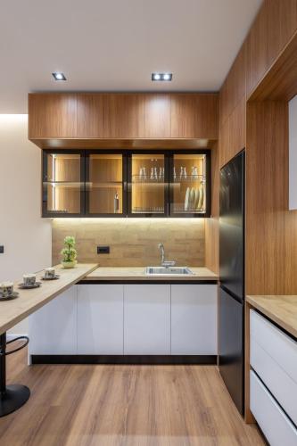 a kitchen with white cabinets and a stainless steel refrigerator at Garden lake City Center New Bazar Tirana in Tirana
