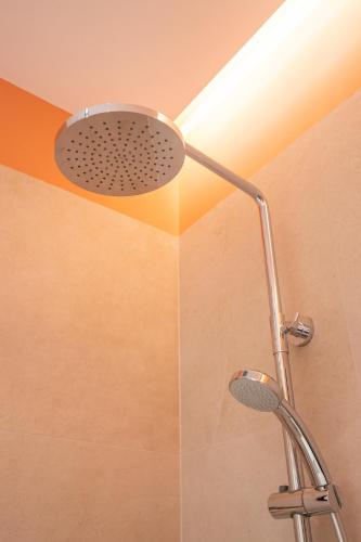 a shower with a shower head in a bathroom at Garden lake City Center New Bazar Tirana in Tirana