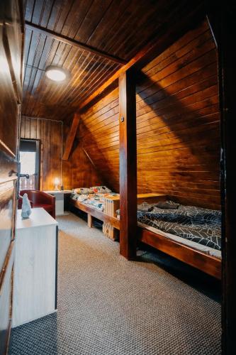 a room with two bunk beds in a cabin at Lake House in Izvoru Mureşului