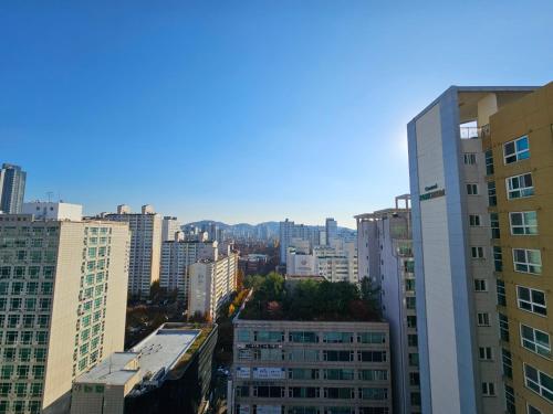 a view of a city with tall buildings at Bucheon Sinjung-dong Station High Floor View Lovely House in Bucheon