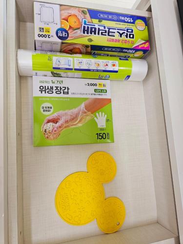 a refrigerator with a drawer with a yellow sign on it at Bucheon Sinjung-dong Station High Floor View Lovely House in Bucheon