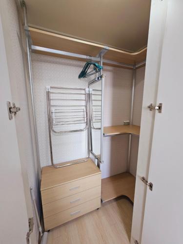 a room with a closet with a window and a wooden floor at Bucheon Sinjung-dong Station High Floor View Lovely House in Bucheon