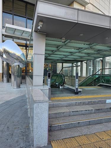 a building with stairs and a escalator in it at Bucheon Sinjung-dong Station High Floor View Lovely House in Bucheon