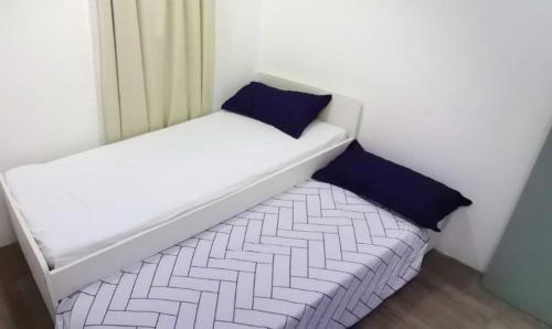 a small bed with two pillows sitting in a room at YUYU B2 Honeymoon WiFi Genting highland in Genting Highlands