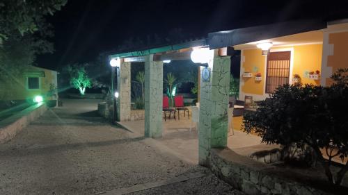 a building with a patio at night with lights at Villa Leonardo in Canicattini Bagni